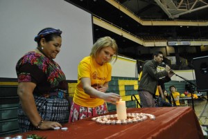 Kaela Thomas lighting a candle with Rigoberta Menchú Tum